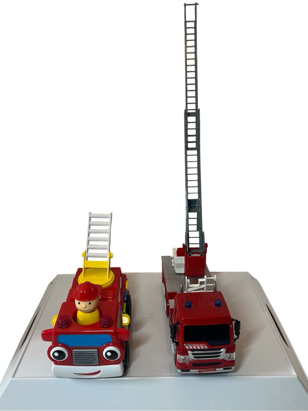 Two Bright Red Toy Fire Trucks with Extendable Ladders and Realistic Sounds.